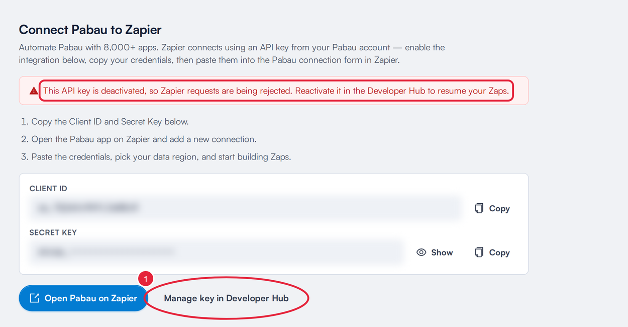 The Zapier page showing the deactivated key warning, with Manage key in Developer Hub marked